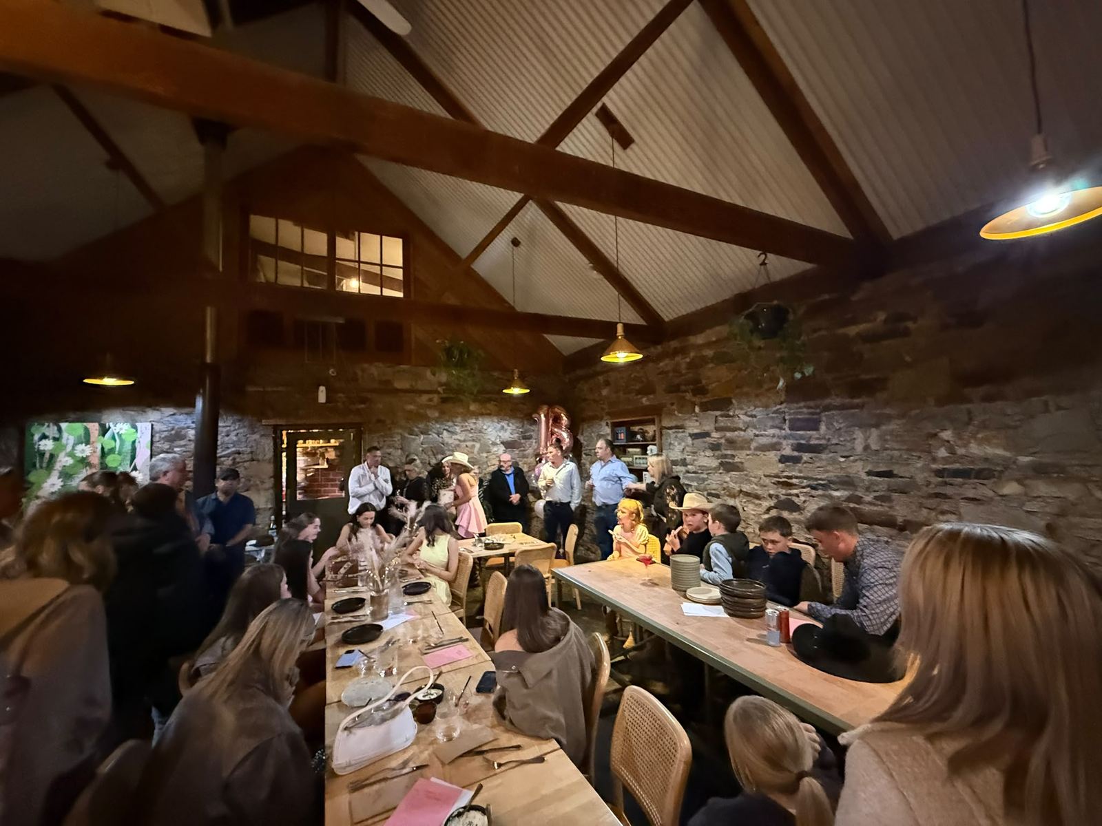 Guests seated along a long table at an Antidote Kitchen private event